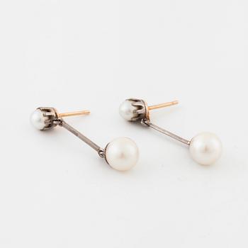 A pair of cultured pearl earrings.