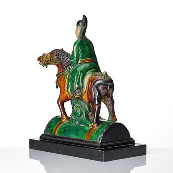 A Chinese glazed stoneware ridge tile figure of a mandarin official on a horse, Ming dynasty (1368-1644).