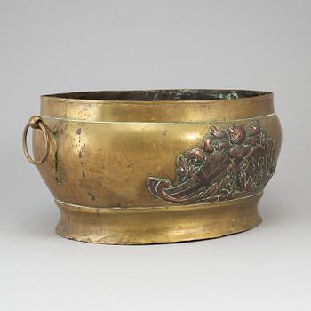 A 17th century brass and copper champagne cooler.