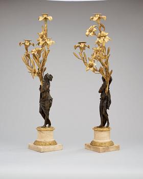 A pair of French Louis XVI-style 19th century three-light candelabra.