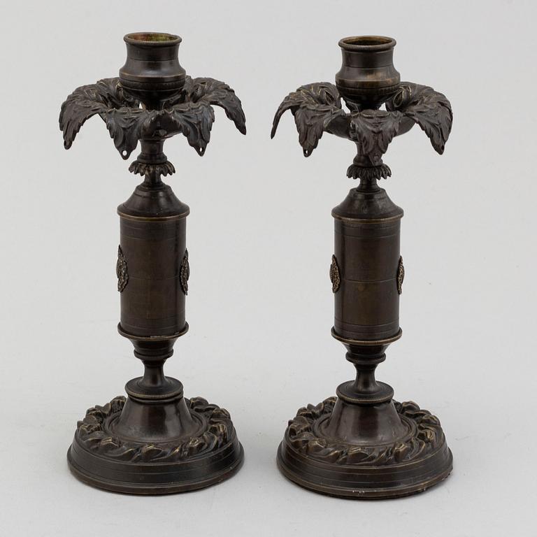 A pair of mid 19th century late Empire candlesticks.