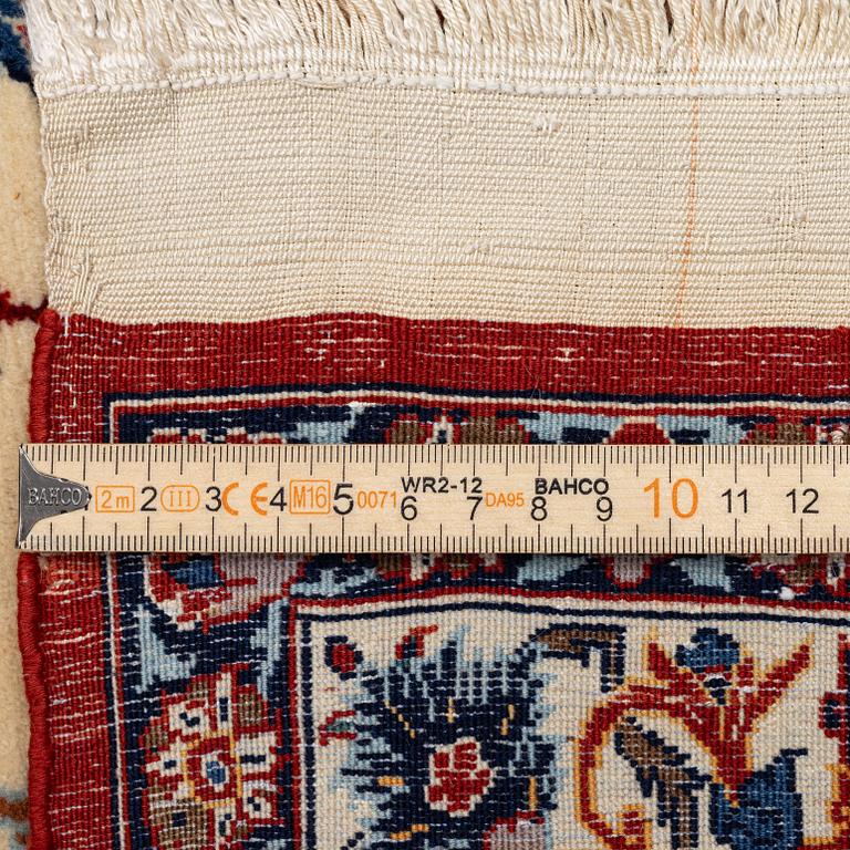 A semi-antique Isfahan carpet, Central Persia, signed (Ali) Seirafian, 328 x 250 cm.
