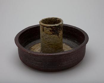 A CERAMIC CANDLESTICK.