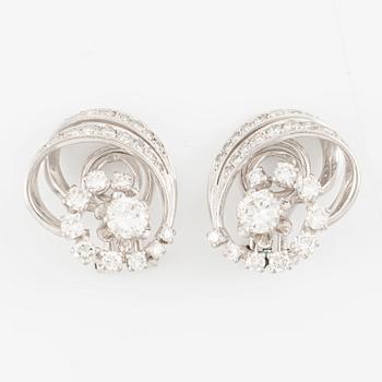 A pair of earrings in 18K white gold set with round brilliant-cut diamonds.