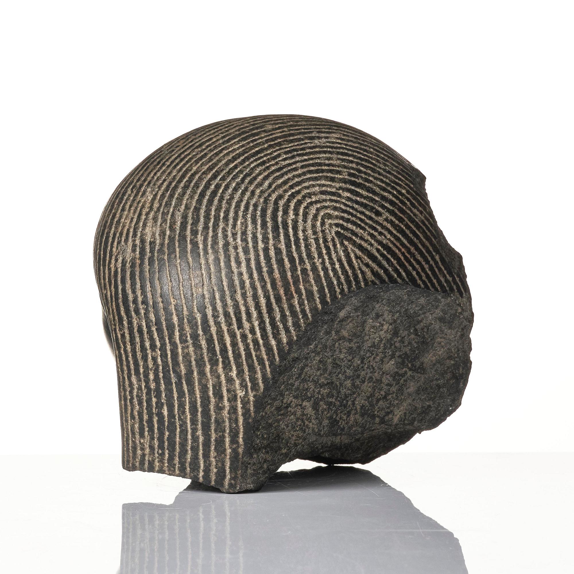 An Egyptian basalt head of a man, Grand tour, 19th century.