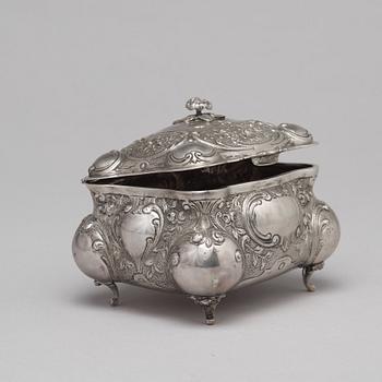 A silver sugar box.