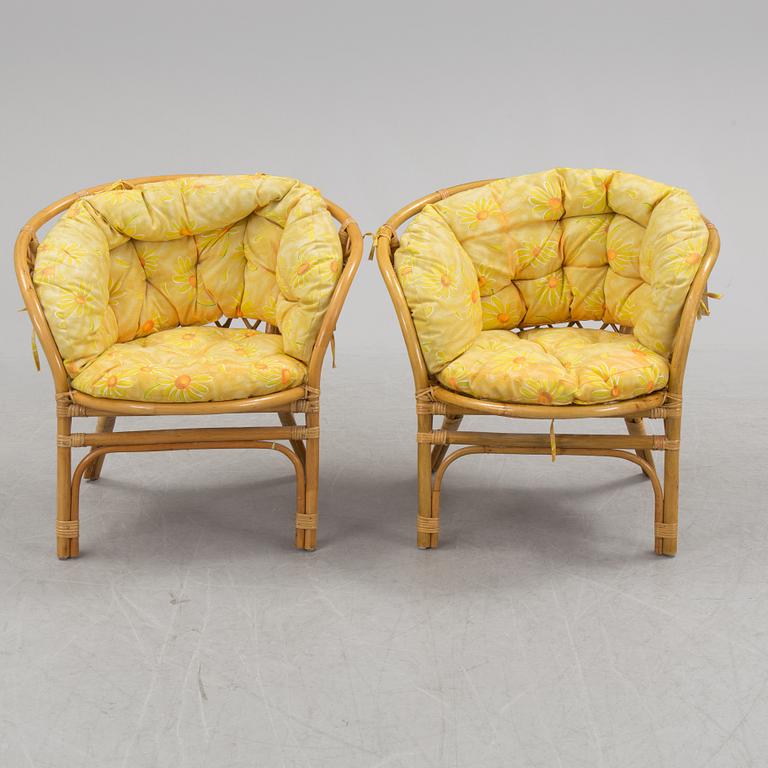 A 1970s four piece set of rattan garden furniture.