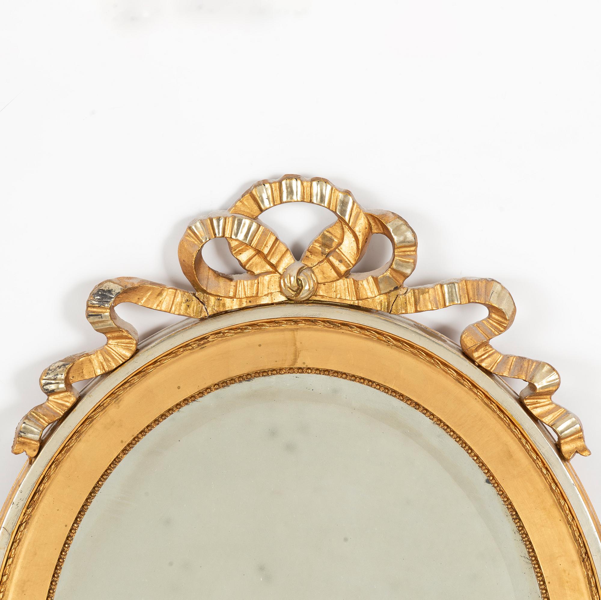 A gustavian style mirror, first half of the 20th century.