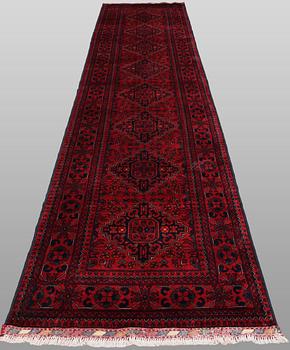 A Afghan runner carpet, 388 x 79 cm.