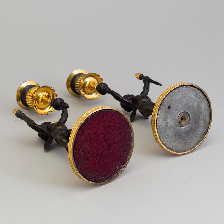 A pair of late 19th century, gilded bronze, Empire style, candle sticks.