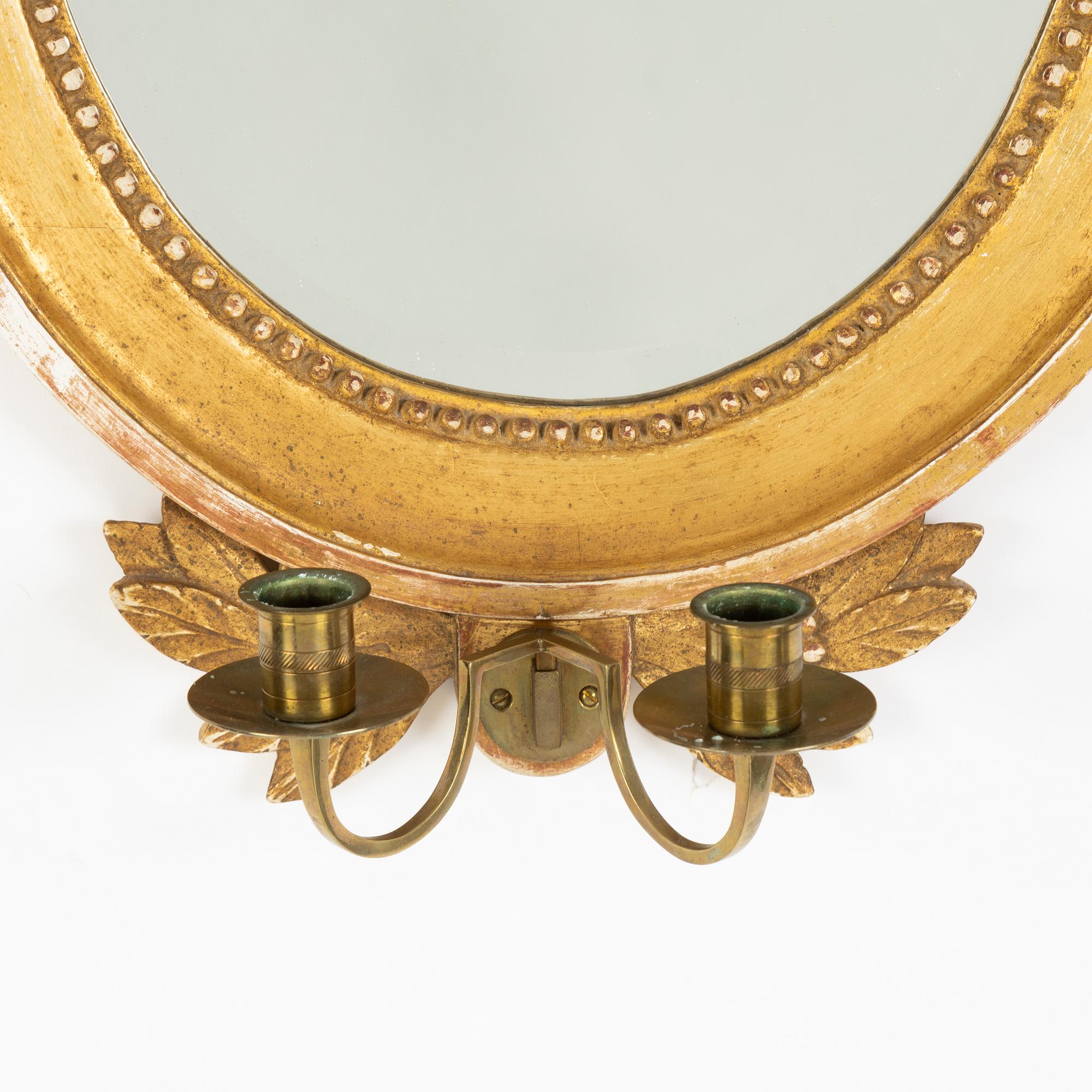 A pair of Gustavian style two-light giltwood girandole mirrors, 20th century.