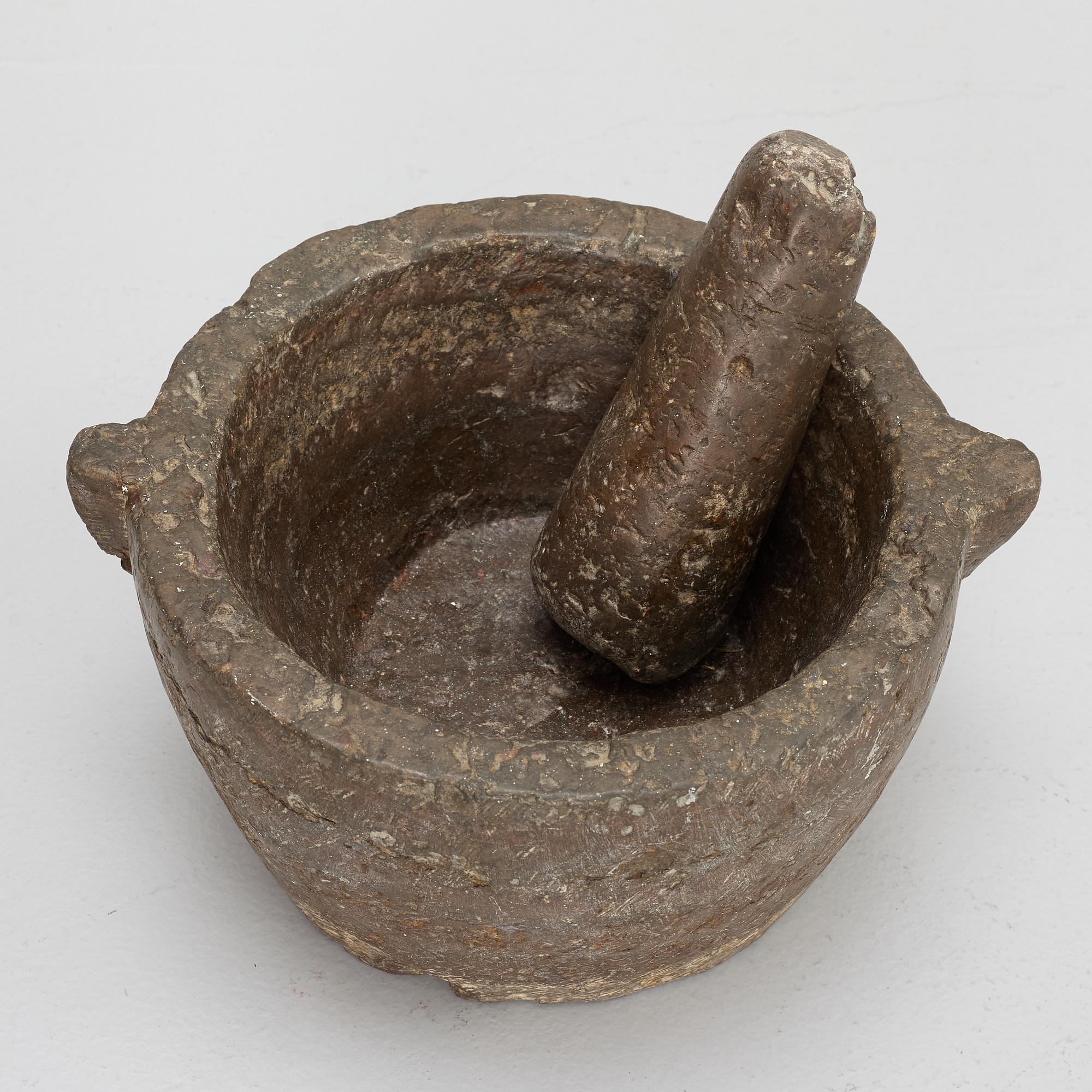 A llimestone mortar and pestle, 18th/19th Century.