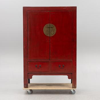 A red-lacquered cabinet, China, 20th century.
