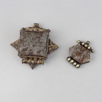 Two metal pendants with turkoise inlay, Tibet, circa 1900.