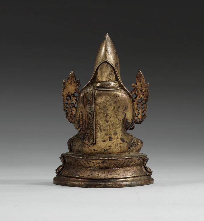 A gilt bronze figure of a Lama, Qing dynasty, 18th Century.