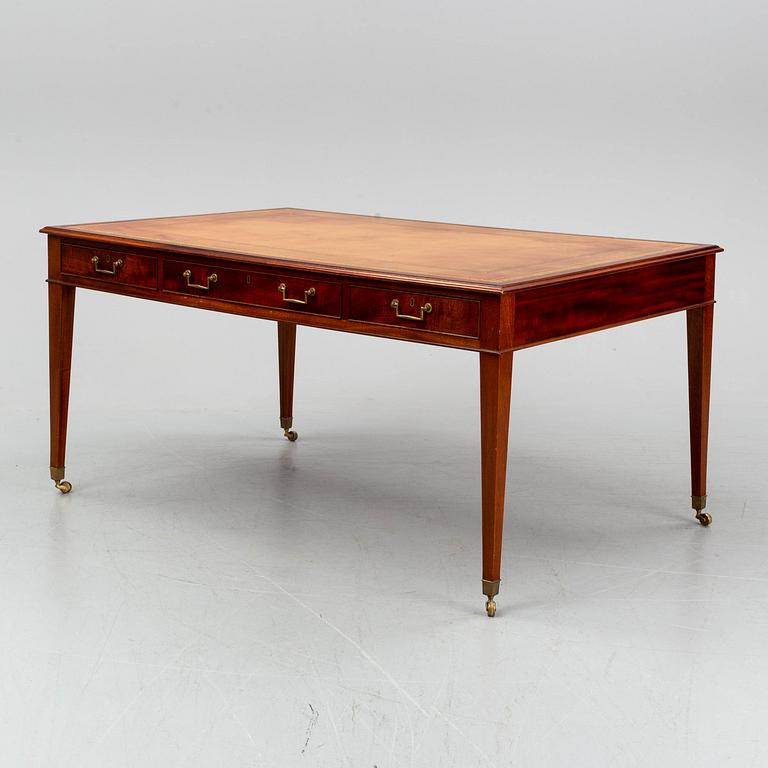 A contemporary mahogany and leather partners desk in the George III style.