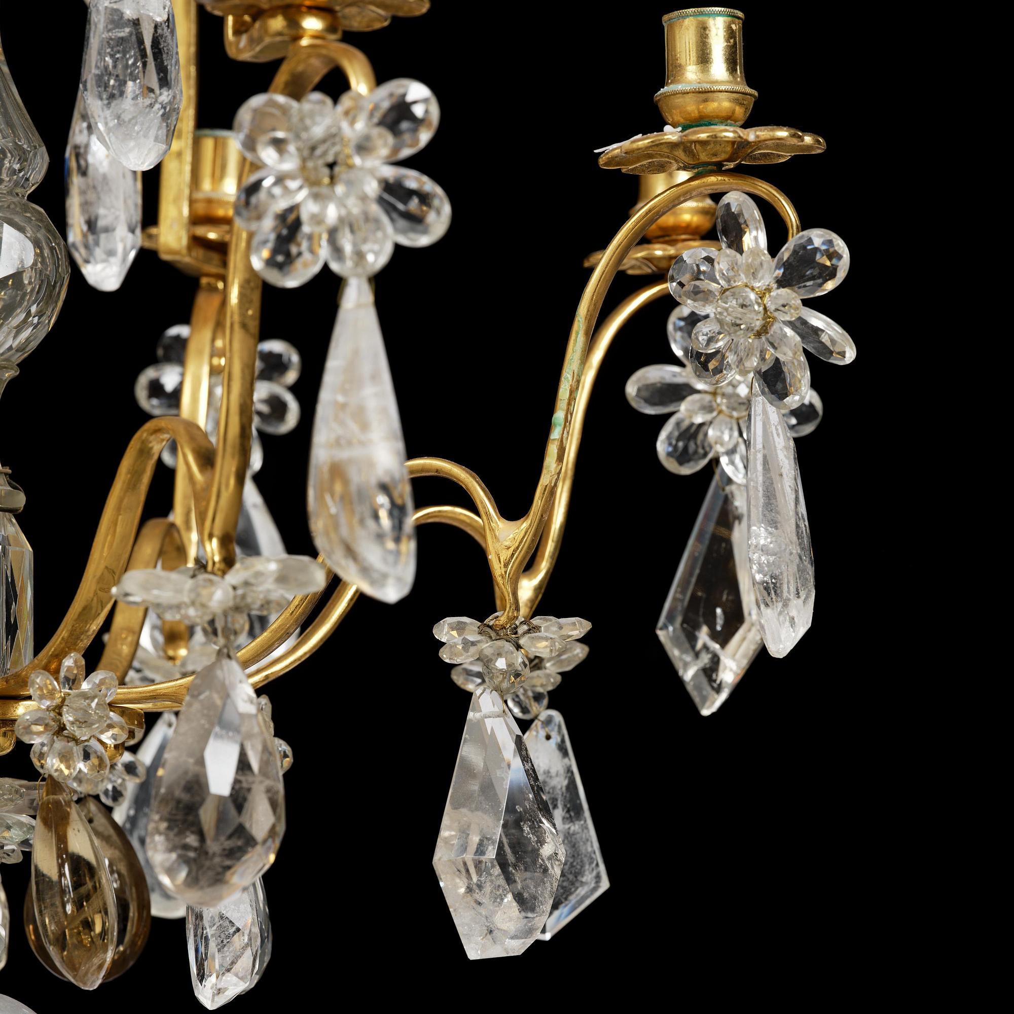 A near pair of Franch Louis-XV-style nine-branch gilt bronze and rock crystal chandeliers, later part 19th century.