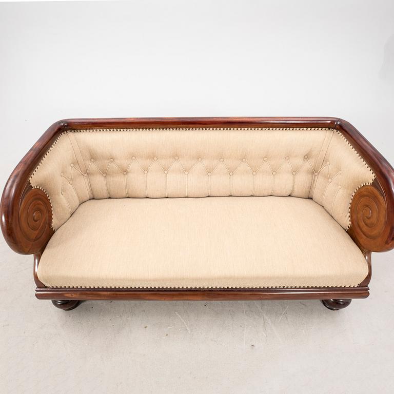 An early 1900s Art deco walnut sofa.