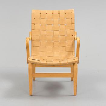 an "Eva" armchair by BRUNO MATHSSON 1963.