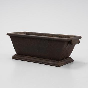 A cast iron plant pot, 20th Century.