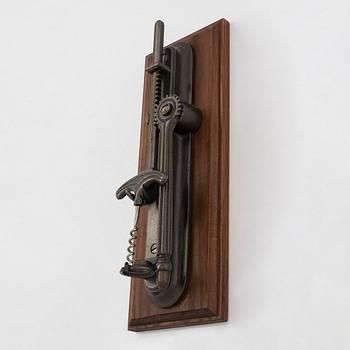 A 21st century French wall-mounted bottle opener.
