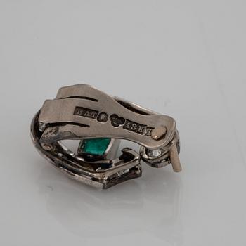 A pair of 18K white gold earrings set with faceted emeralds and old- and eight-cut diamonds.
