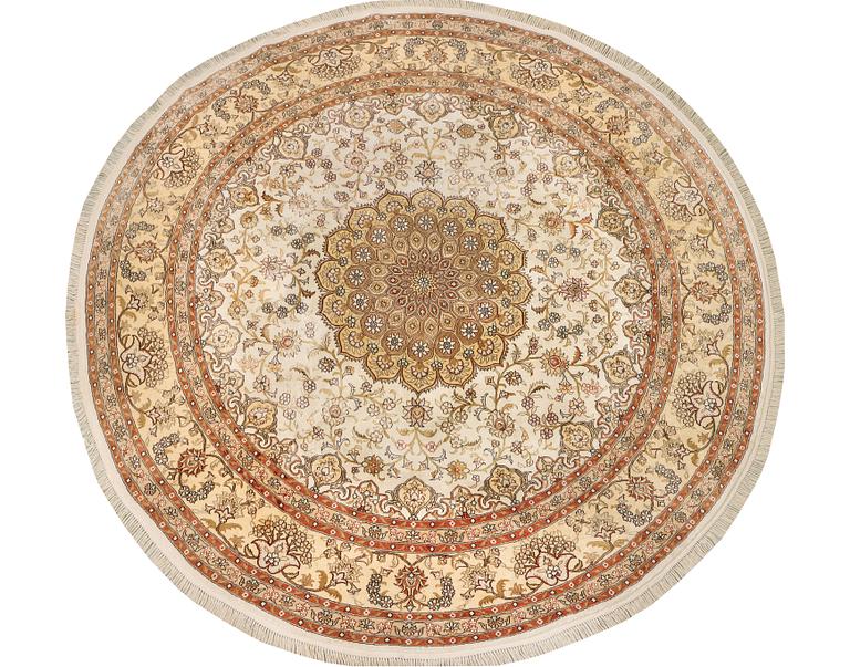 An oriental silk rug, diameter c. 216 cm.