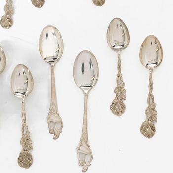 A pair of beakers, two napkin rings, and 17 pieces of cutlery, silver.