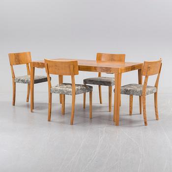 A 1940's dining table an four chairs.