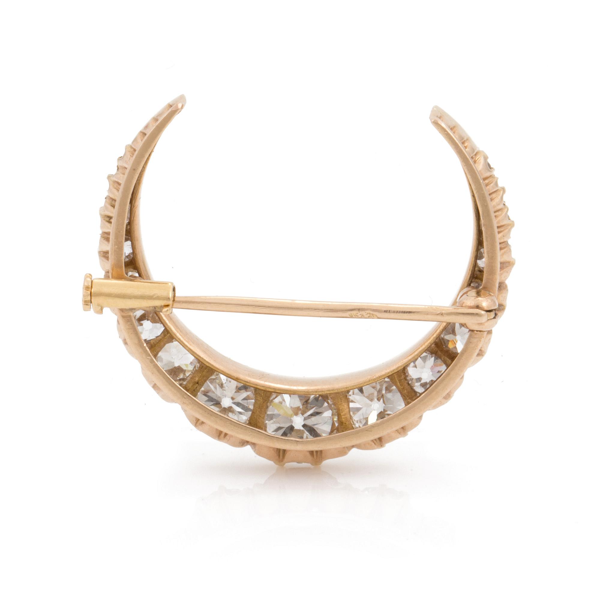 A gold and circa 2.85 ct old cut diamond crescent brooch. Probably late 1800s.