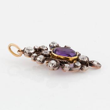 A silver and gold pendant set with a faceted amethyst and old- and rose-cut diamonds.