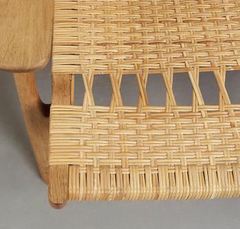 A pair of Hans J Wegner oak and rattan easy chairs 'CH-27', Carl Hansen & Son, Denmark.