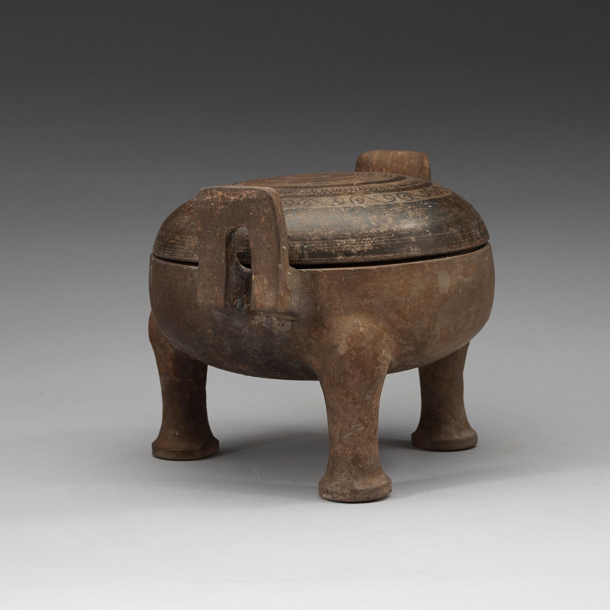 A pottery tripod censer, Han dynasty (206 B.C. -220 A.D.).