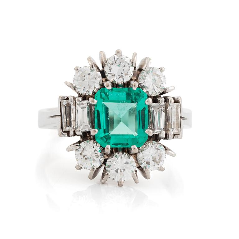 An 18K white gold ring set with a step-cut emerald.