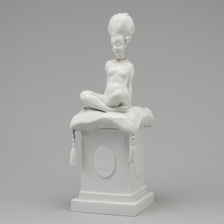 A white glazed Royal Copenhagen porcelain nodding head figure, Denmark, early 20th Century. Not first quality.