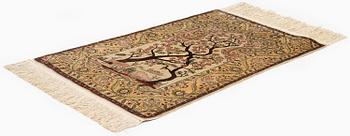 A semi-antique / old silk Hereke rug, West Anatolia, c. 100 x 60 cm.