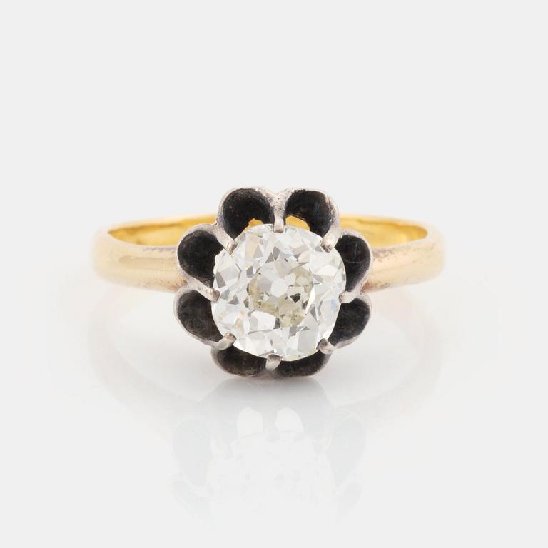 An 18K gold and silver ring set with an old-cut diamond.