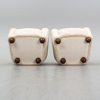 A pair of 1940's lounge chair with later sheepskin upholstery.