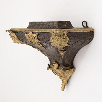 A 19th century rococo style clock, and a 18th century rococo console.