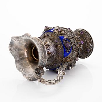 A parcel-gilt silver jug with enamel, and cabochon cut amethysts. First half of the 20th century.