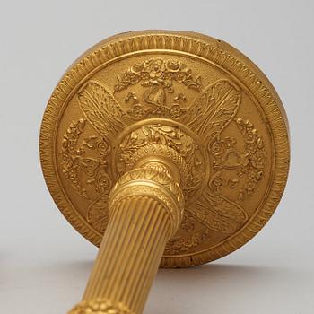 A pair of French Empire early 19th century gilt bronze candlesticks.