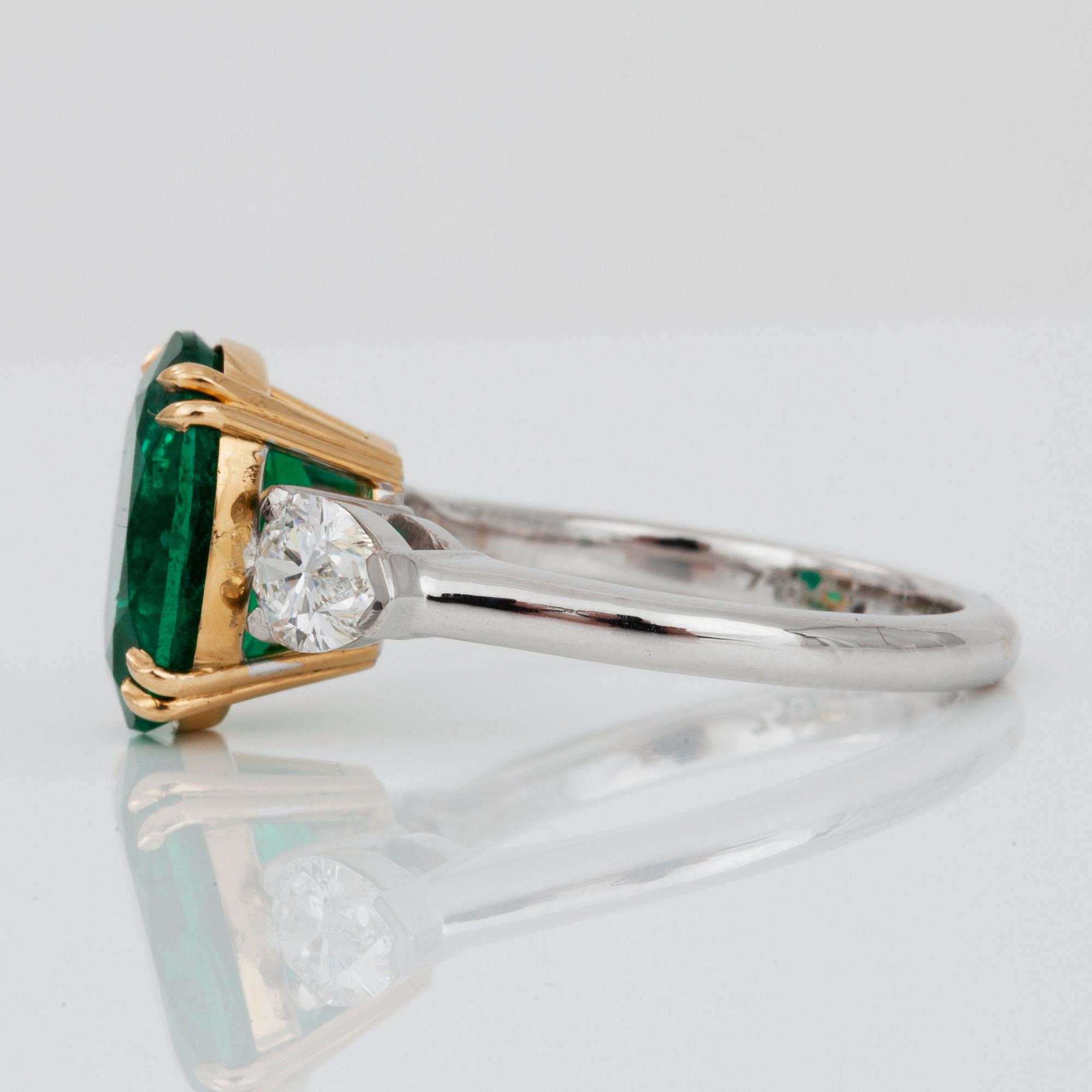 An emerald, circa 3.85 cts and diamond, circa 1.00 ct in total, ring.