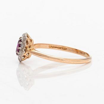 A 14K gold ring, with a pink sapphire and diamonds.