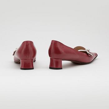 LOUIS VUITTON, a pair of red leather shoes.