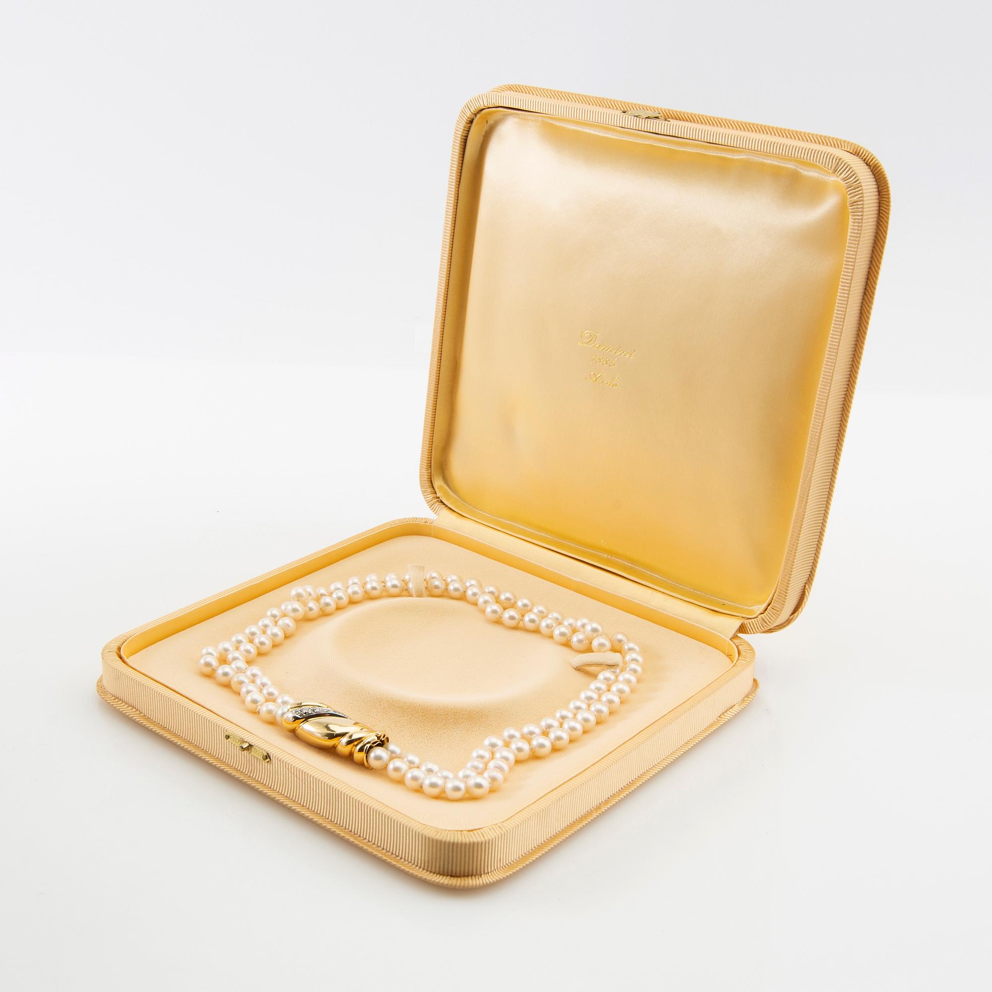 Necklace, two-stranded of cultured pearls with a clasp of 18K gold set with brilliant-cut diamonds, Damini Asolo Italy.