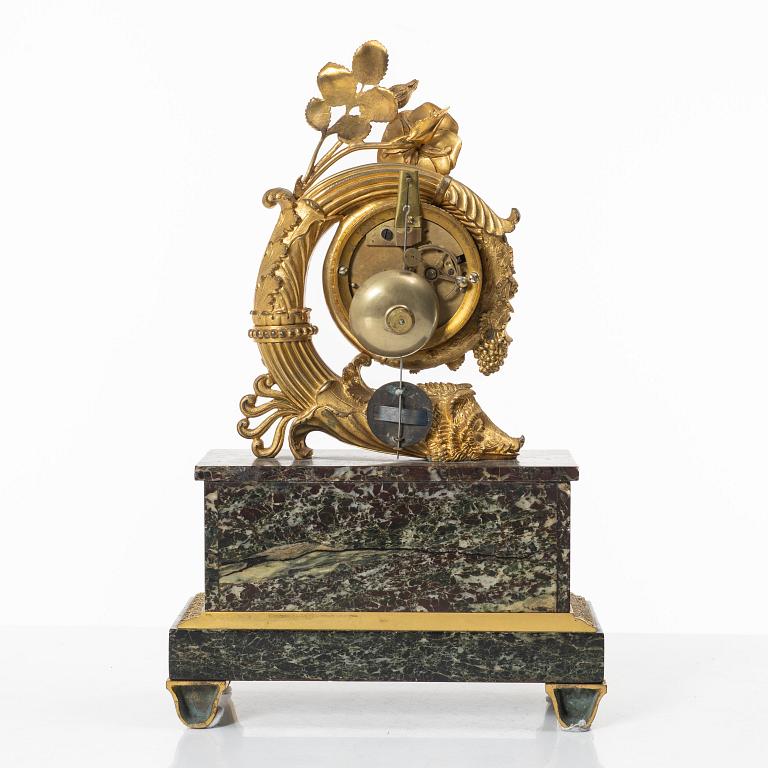 A presumably French Empire-style gilt bronze and marble mantel clock, later part 19th century.