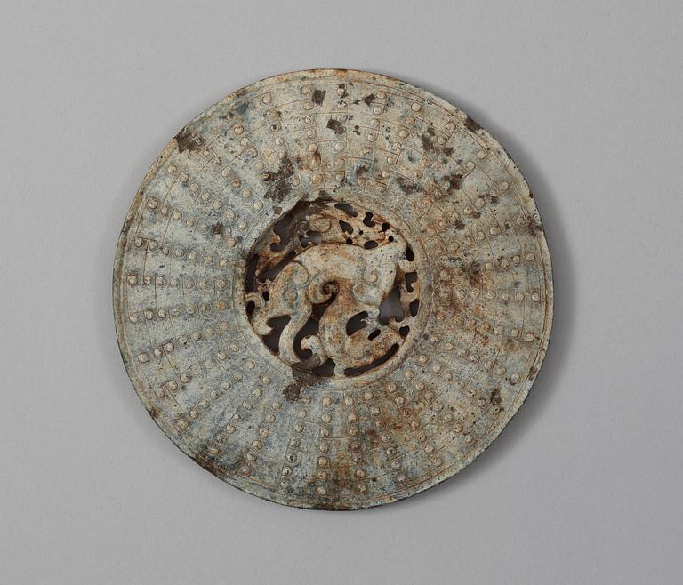 A carved archaistic nephrite bi disc.