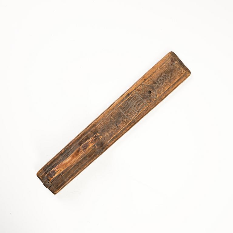 A Swedish folk art carved wringer, dated 1669.