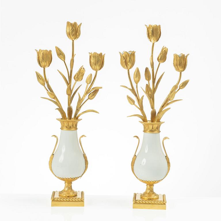 A pair of three light porcelain and gilt bronze three-branch Louis XV-style candelabra, mid 19th century.