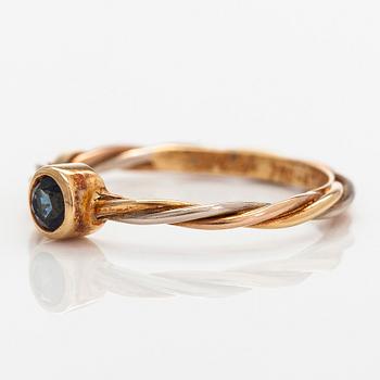 Cartier, an 18K tri-colour gold ring with a sapphire.